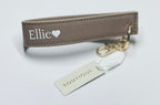 Keychain with 'Ellie' branding on a light gray background