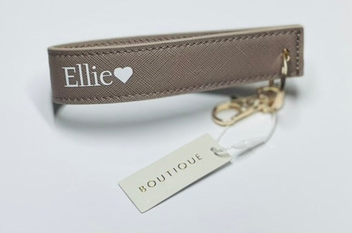 Keychain with 'Ellie' branding on a light gray background